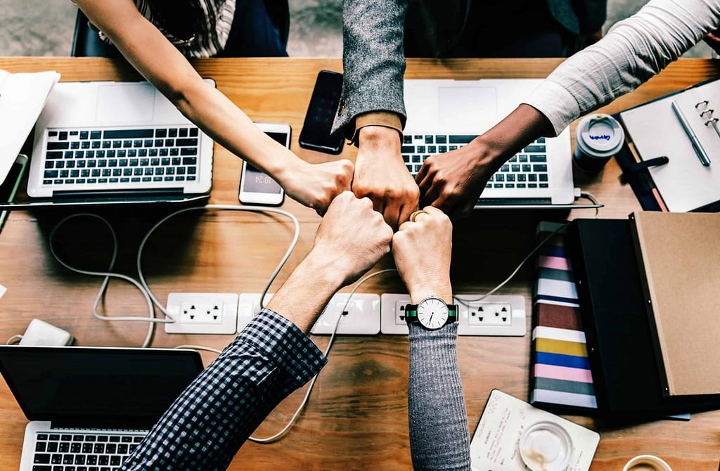 fist pound - hands in over desk