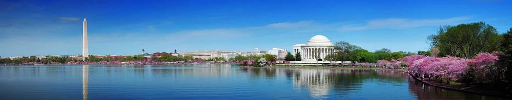 a white building next to a body of water